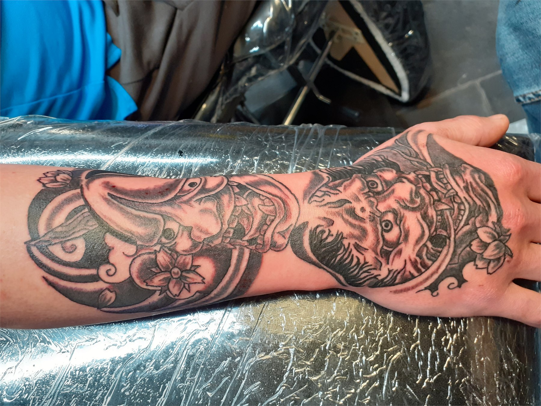 Japanese koi and floral black and grey forearm tattoo