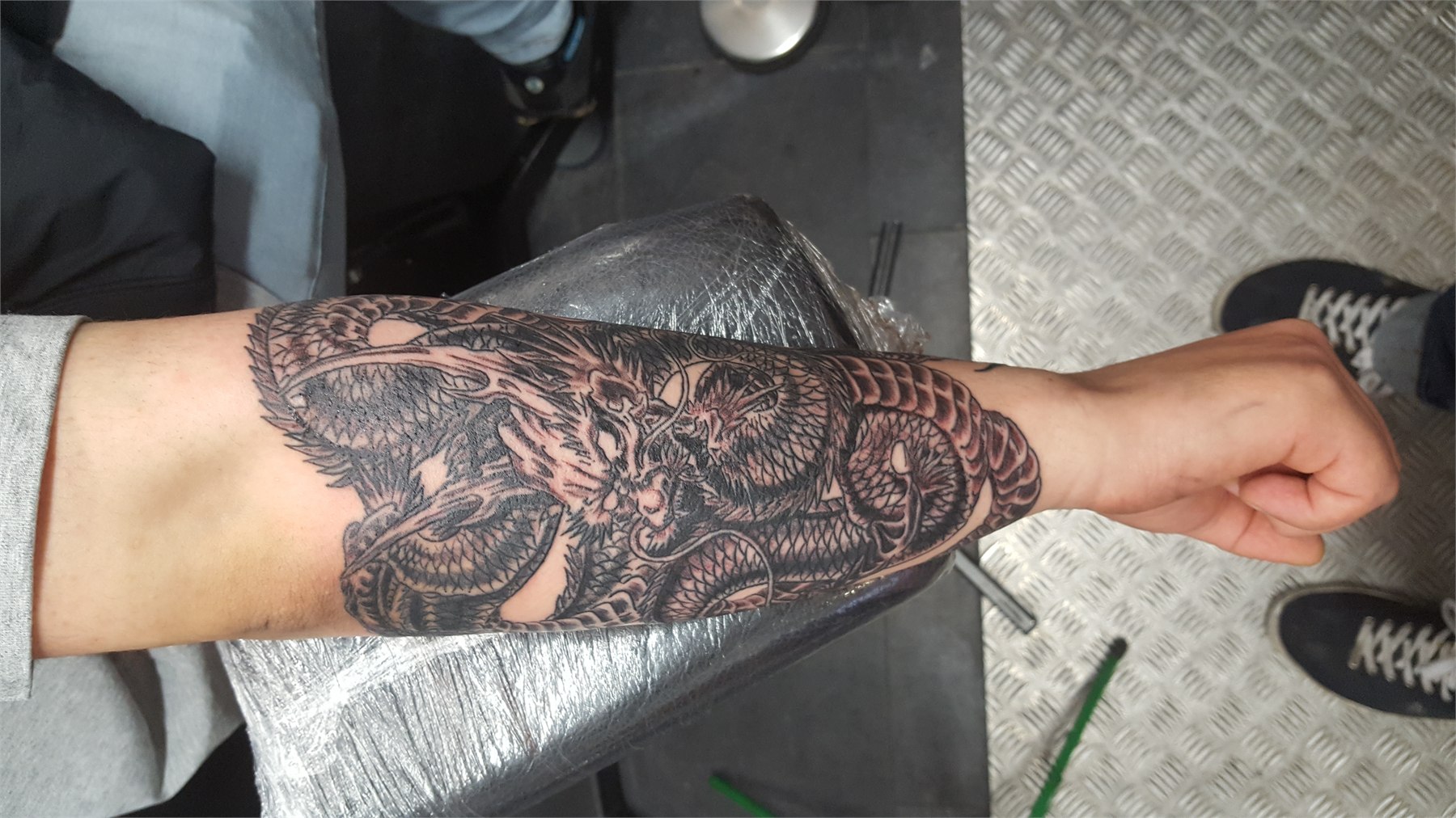Black and grey ornamental mandala forearm tattoo