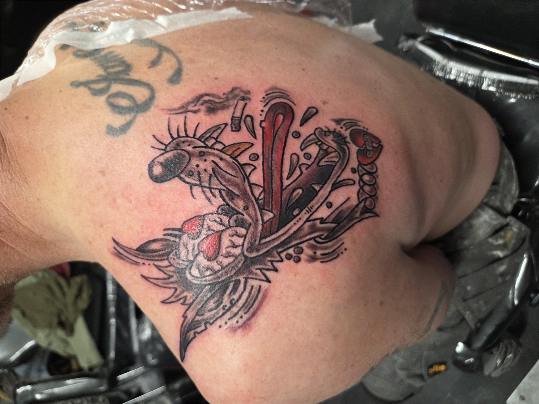 Sacred heart and wings tattoo with red accents